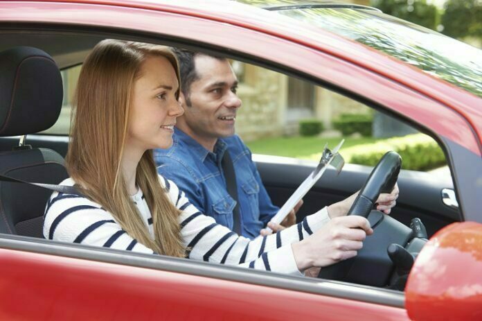 Woman Having Driving Lesson With Instructor